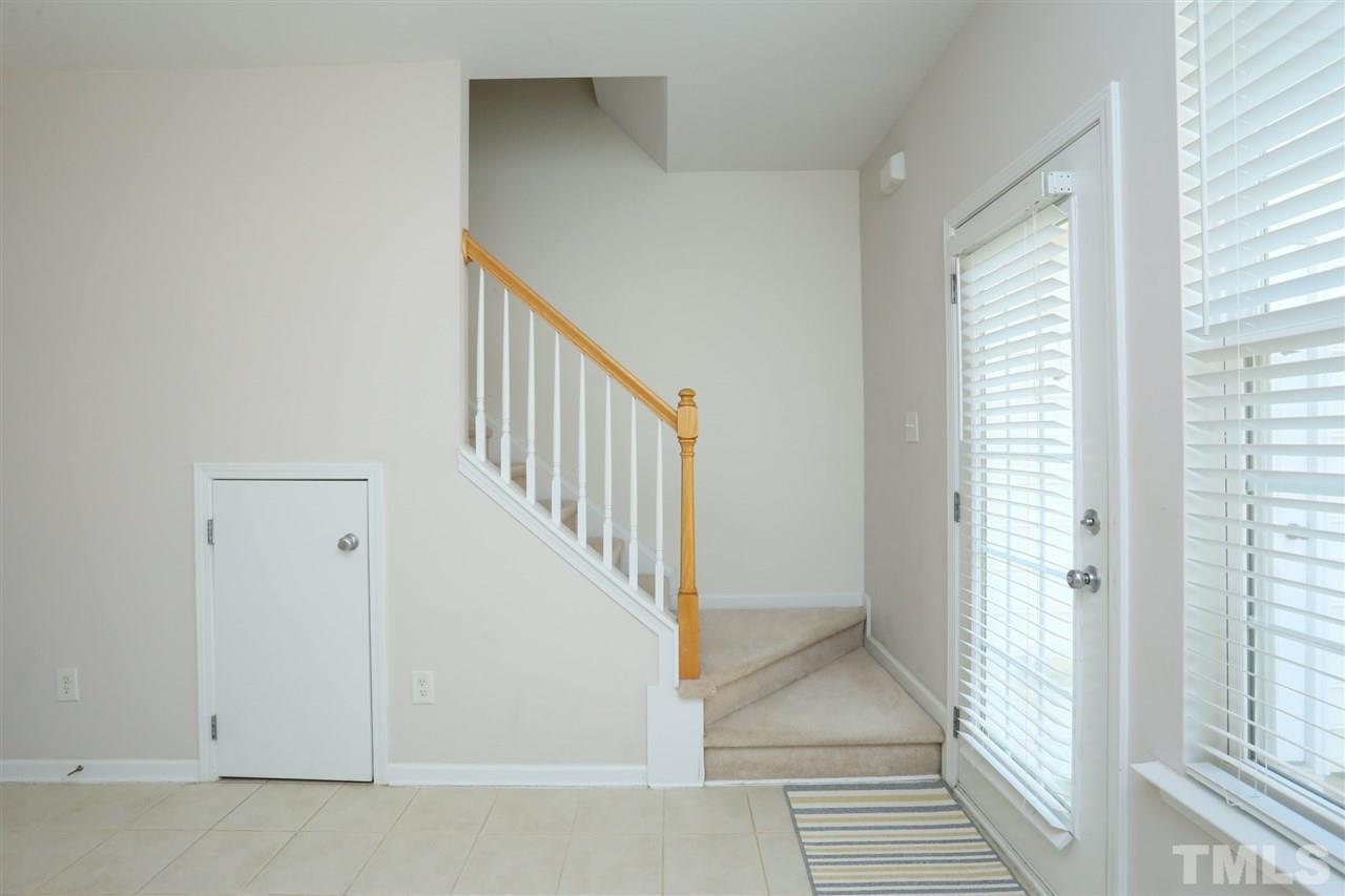 8228 City Loft Court Raleigh, NC 27613 - Photo 13 of 27 a view of a hallway with wooden floor and entryway