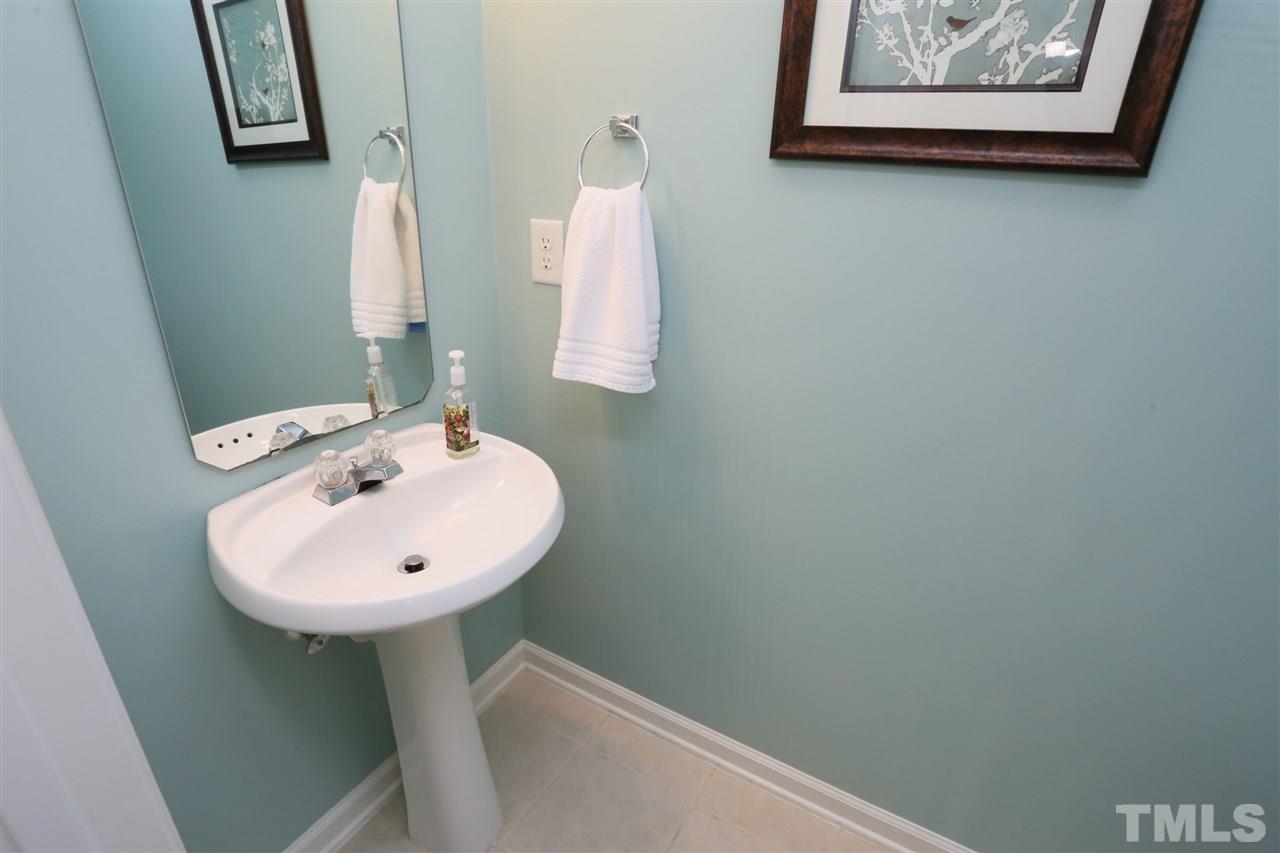 8228 City Loft Court Raleigh, NC 27613 - Photo 14 of 27 a bathroom with a sink and a mirror