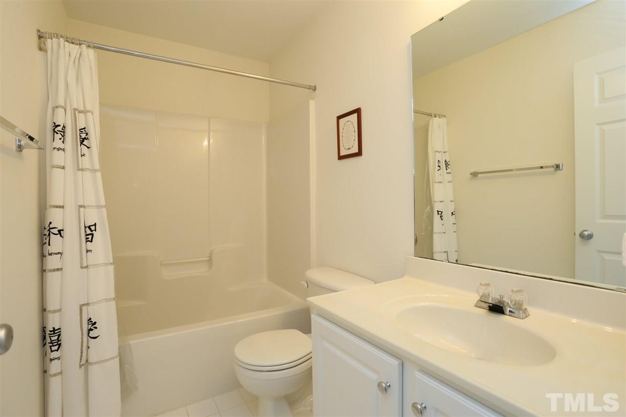 8228 City Loft Court Raleigh, NC 27613 - Photo 22 of 27 a bathroom with a sink toilet and shower