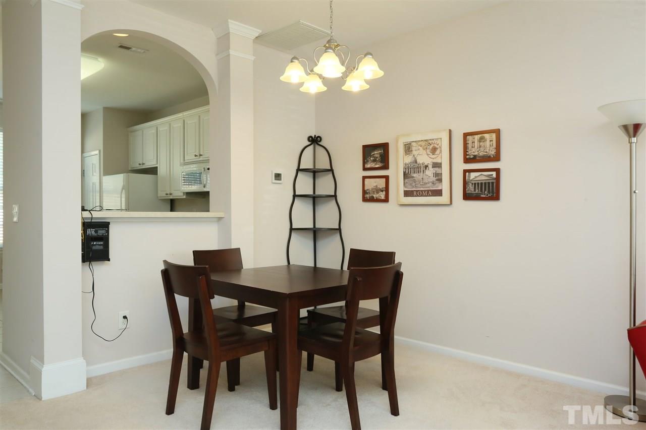 8228 City Loft Court Raleigh, NC 27613 - Photo 7 of 27 a view of a dining room with furniture and chandelier