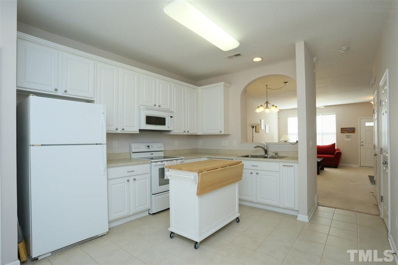 8228 City Loft Court Raleigh, NC 27613 - Photo 9 of 27 a kitchen with a refrigerator sink and cabinets
