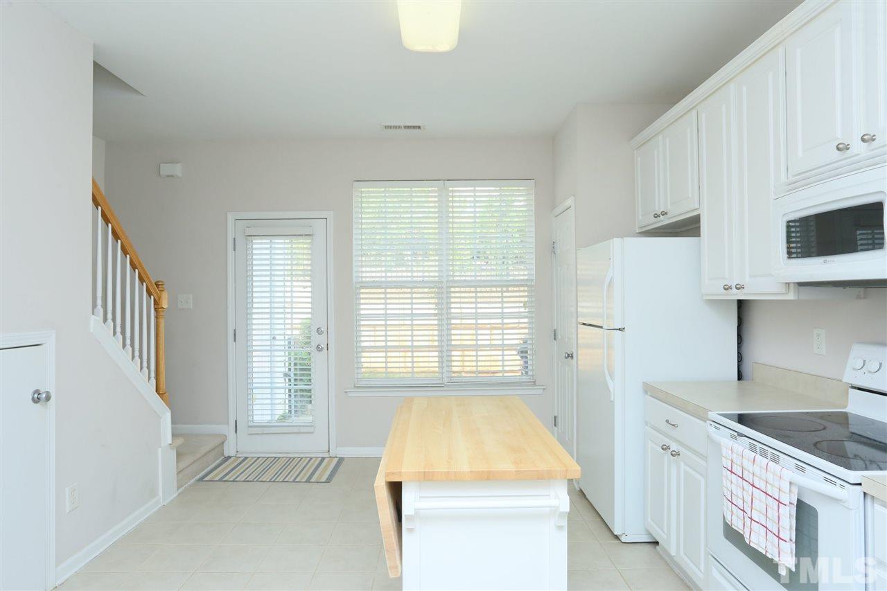 8228 City Loft Court Raleigh, NC 27613 - Photo 10 of 27 a spacious bathroom with a granite countertop tub sink and mirror