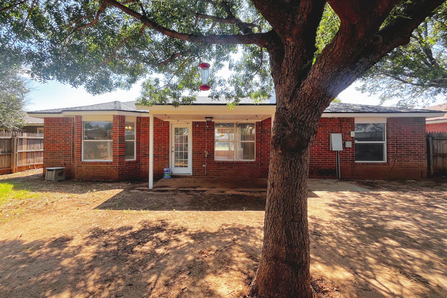 6114 10th Street Lubbock, TX 79416 - Photo 22 of 24 a view of a house with a yard covered in snow