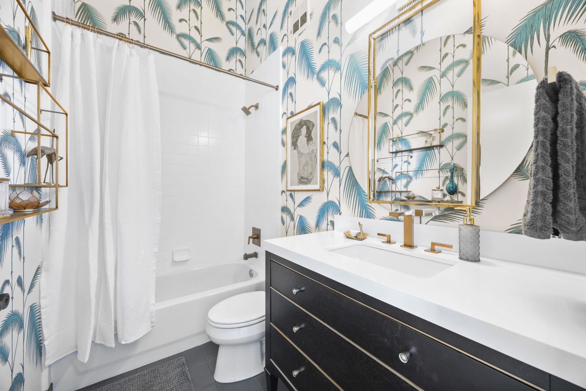 1007 41st Street, Unit 334 Oakland, CA 94608 - Photo 43 of 59 a bathroom with a sink a toilet and a mirror