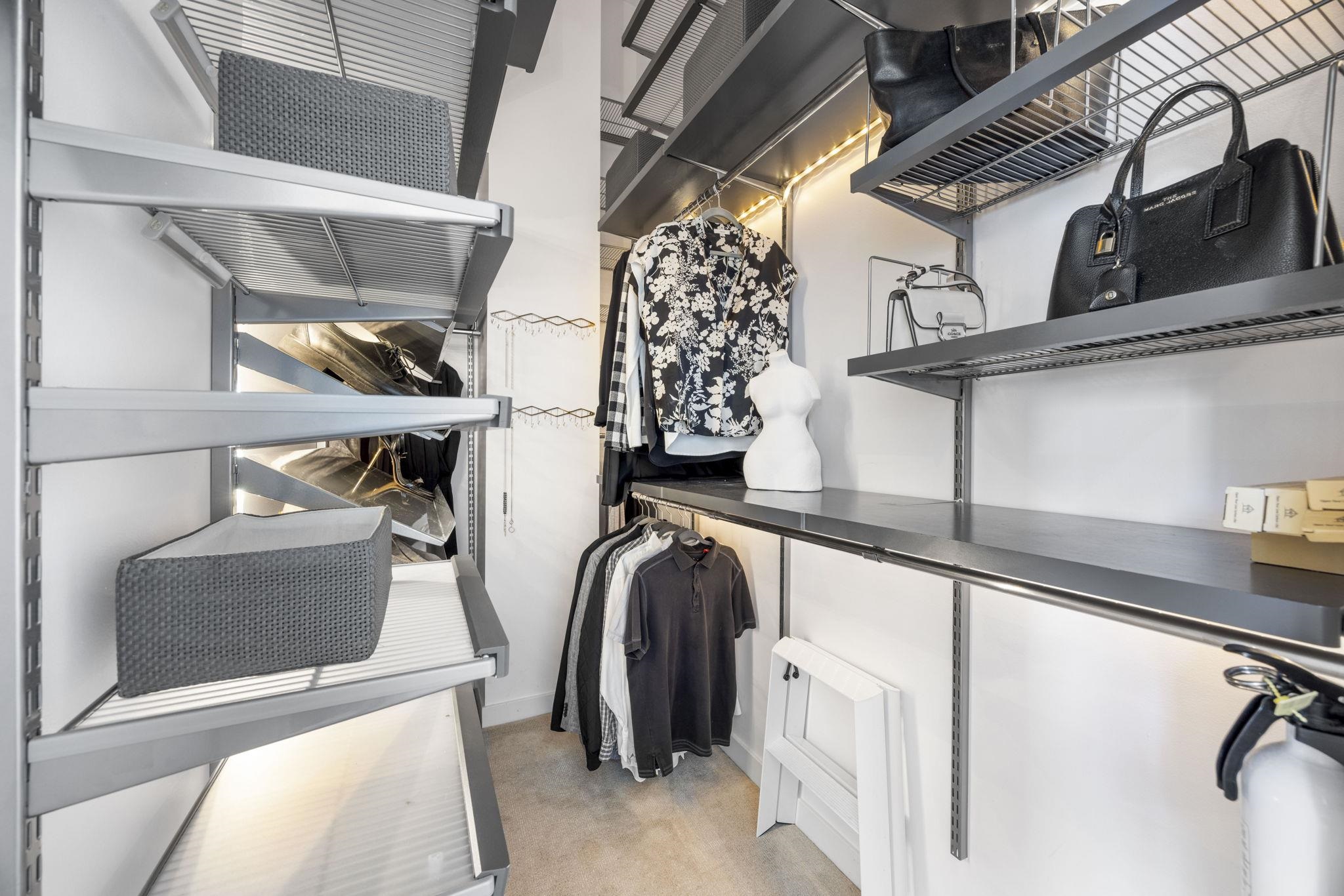 1007 41st Street, Unit 334 Oakland, CA 94608 - Photo 47 of 59 a view of walk in closet with clothes and shoes