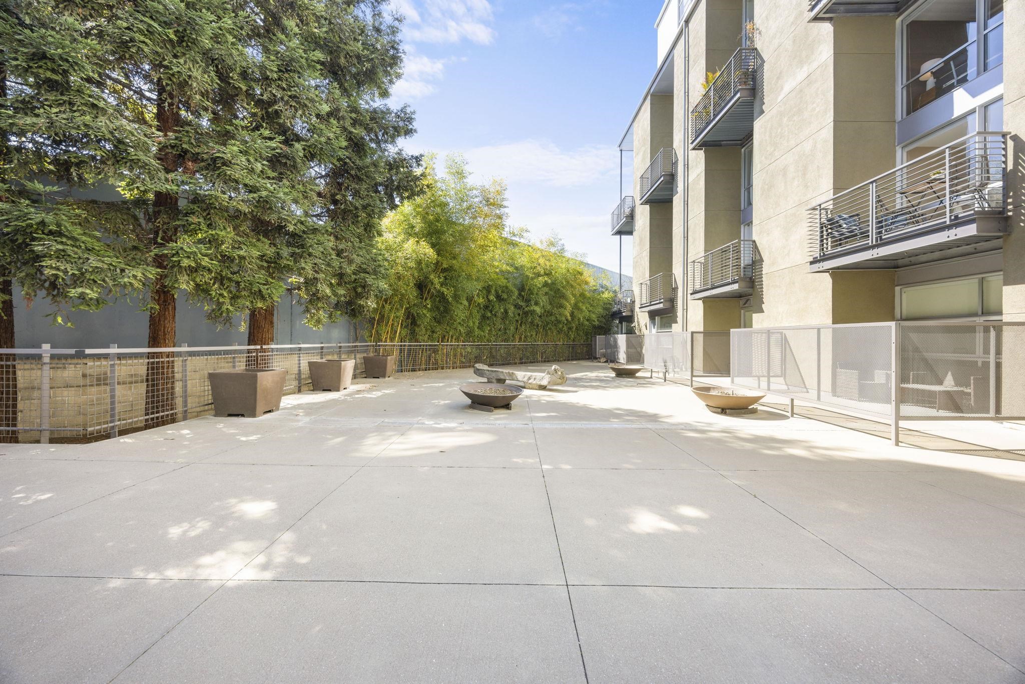 1007 41st Street, Unit 334 Oakland, CA 94608 - Photo 50 of 59 a view of a building with a bench in front of building
