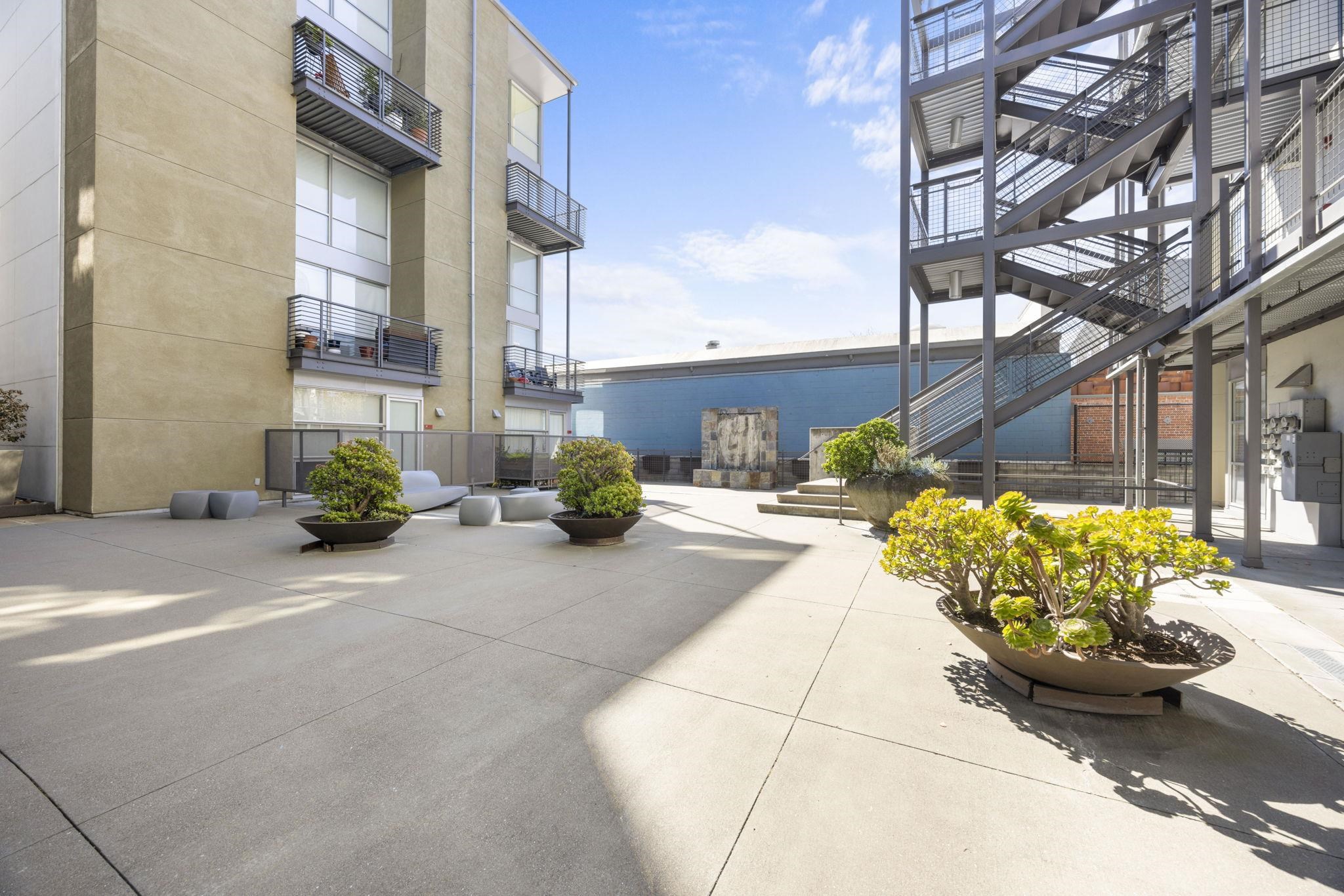 1007 41st Street, Unit 334 Oakland, CA 94608 - Photo 52 of 59 a view of a street with potted plants