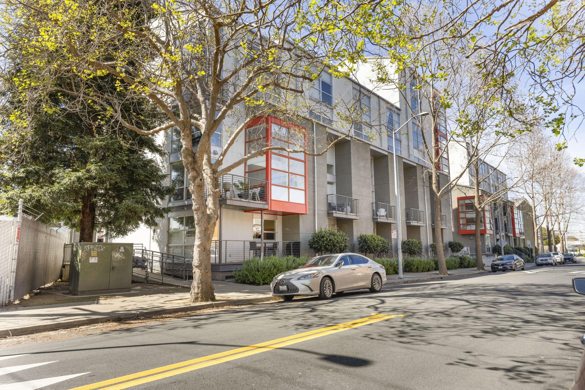 1007 41st Street, Unit 334 Oakland, CA 94608 - Photo 56 of 59 a white house that has a tree in front of it
