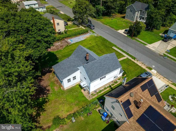 an aerial view of a house with garden space and street view