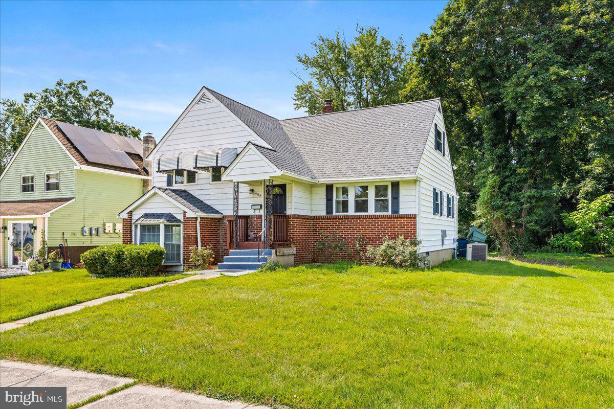 404 Franklin Road Glassboro, NJ 08028 - Photo 2 of 24 a front view of a house with a yard and trees
