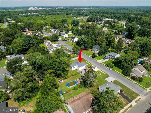 an aerial view of a houses with a yard