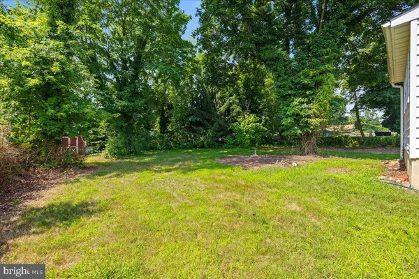 a view of backyard with swimming pool