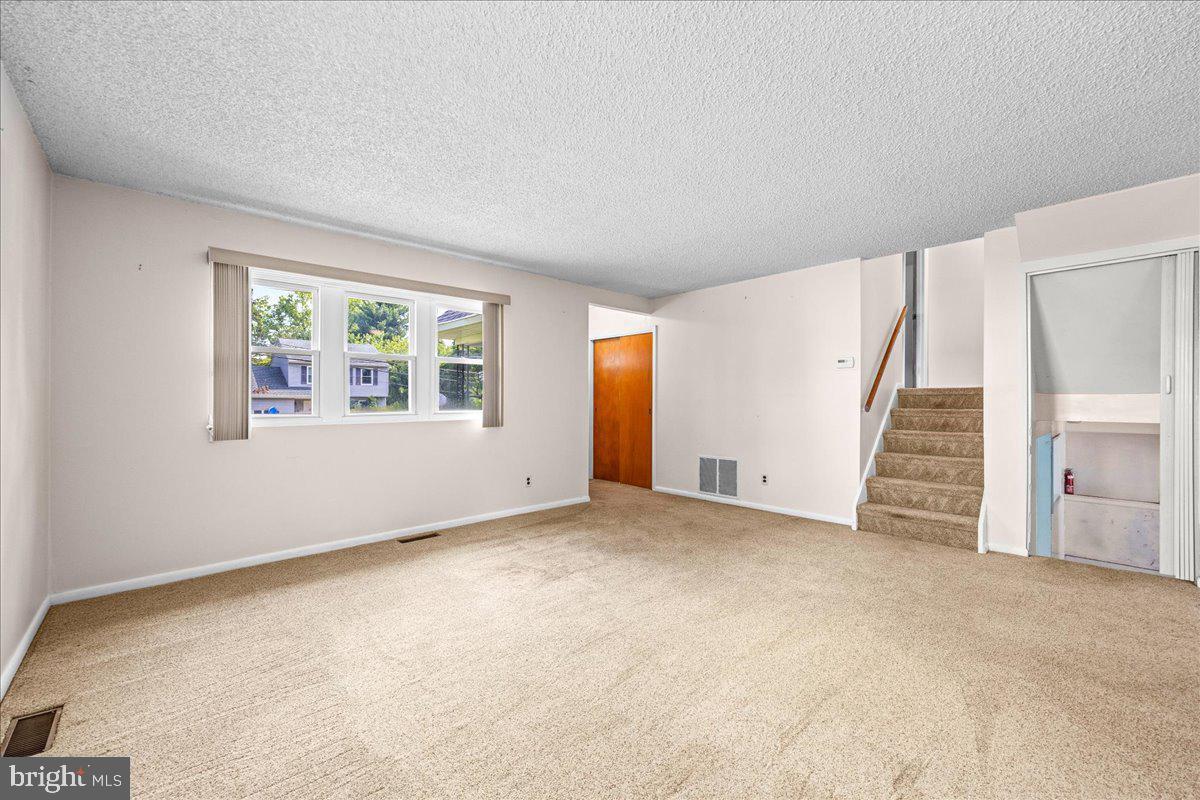 404 Franklin Road Glassboro, NJ 08028 - Photo 7 of 24 an empty room with a window and stairs