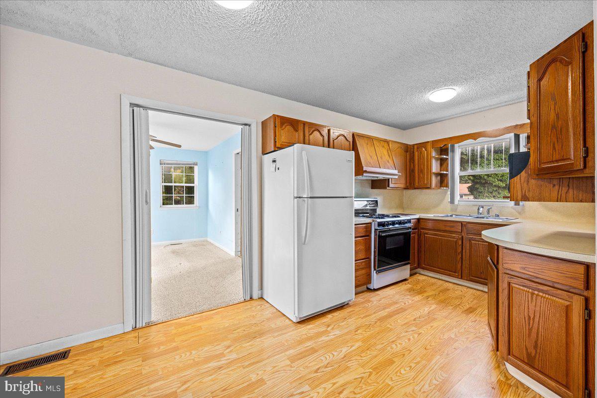 404 Franklin Road Glassboro, NJ 08028 - Photo 8 of 24 a kitchen with stainless steel appliances a refrigerator and a stove top oven