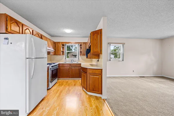 a kitchen with a refrigerator a sink and a stove