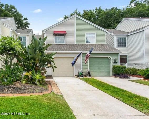 a front view of house with yard and green space