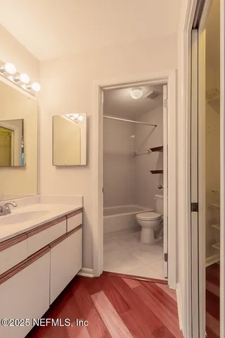 a view of empty room with wooden floor and fireplace