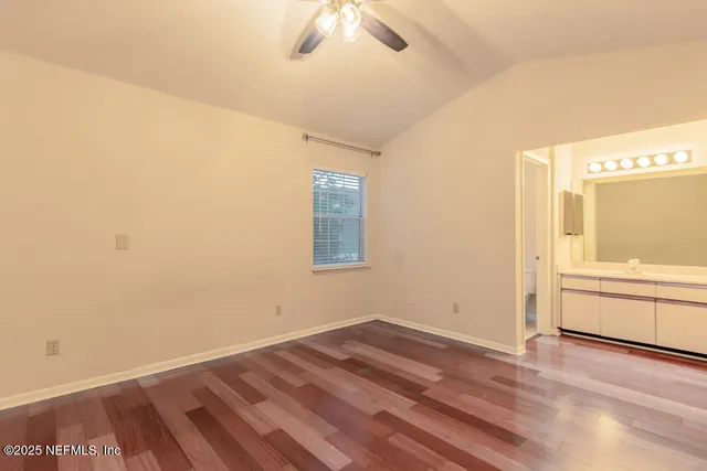 a kitchen with stainless steel appliances white cabinets white stove a refrigerator and a microwave