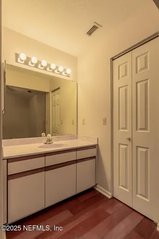 a view of empty room with fireplace and wooden floor