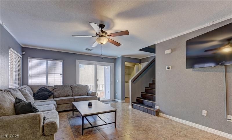 10456 Processor Court Las Vegas, NV 89129 - Photo 2 of 8 Tiled living room with crown molding, a ceiling fa