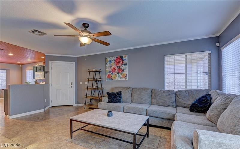 10456 Processor Court Las Vegas, NV 89129 - Photo 3 of 8 Living area featuring visible vents, crown molding
