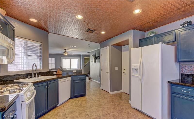10456 Processor Court Las Vegas, NV 89129 - Photo 5 of 8 Kitchen with visible vents, dark countertops, whit