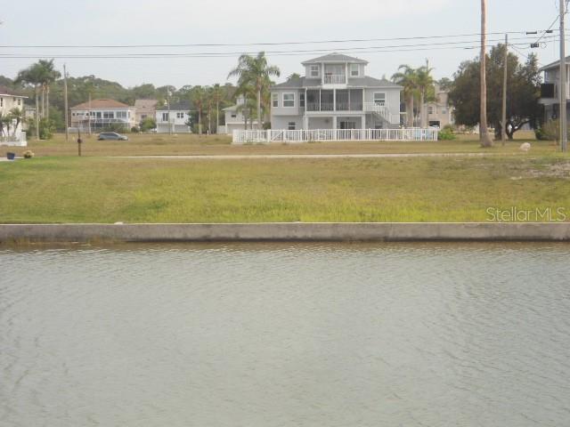 3415 Triggerfish Drive Hernando Beach, FL 34607 - Photo 1 of 4 a view of a lake with a large building