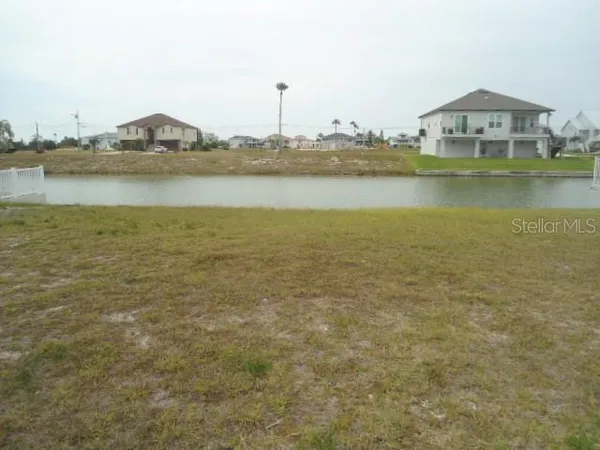 a view of a lake with houses in the background