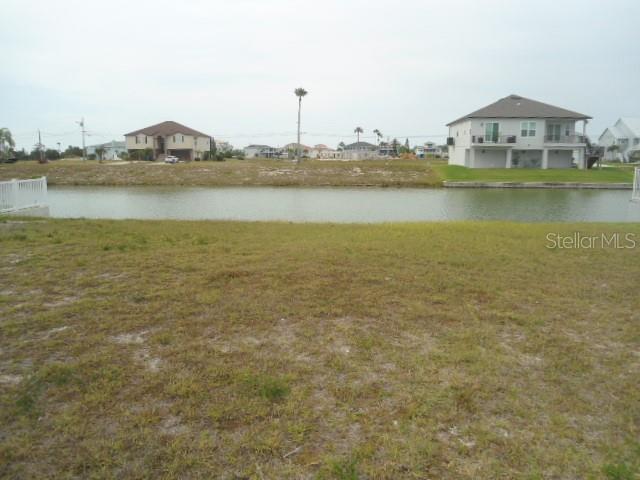 3415 Triggerfish Drive Hernando Beach, FL 34607 - Photo 2 of 4 a view of a lake with houses in the background