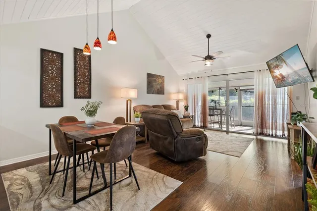 a livingroom with furniture wooden floor and a chandelier