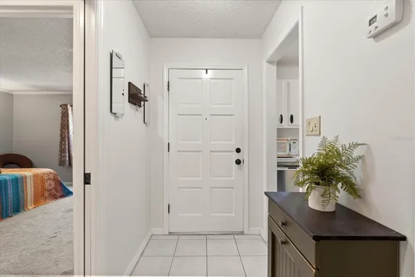 a bedroom with a bed a table and a window