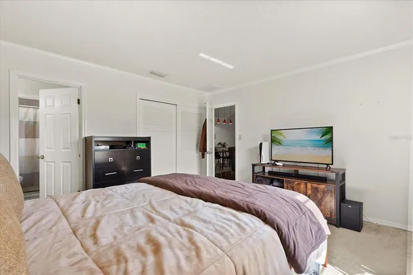 a bedroom with a bed and a dresser