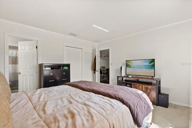 a bedroom with a bed and a dresser