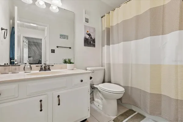 a dining room filled with glass windows and furniture