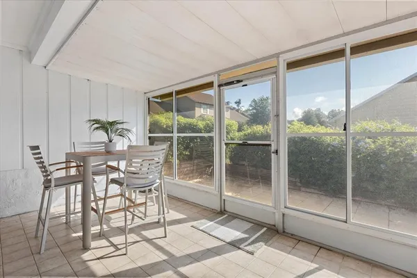 a dining room with furniture and glass door
