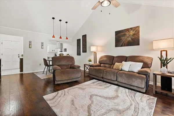 a living room with furniture and a wooden floor