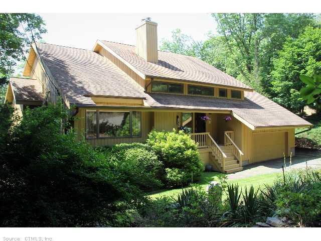 172 Center Road Woodbridge, CT 06525 - Photo 1 of 1 a front view of a house with a garden