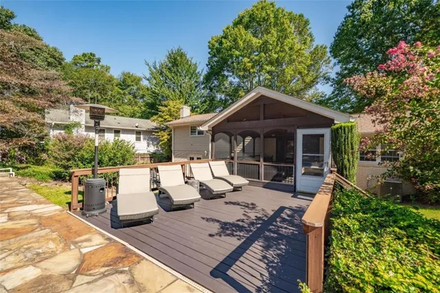 a view of a patio with couches table and chairs and potted plants