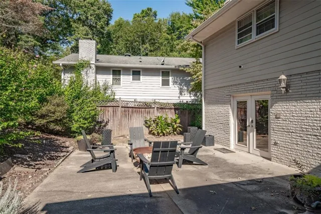 a view of a patio with table and chairs and potted plants