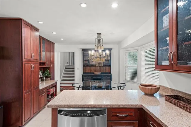 a view of a kitchen with stainless steel appliances granite countertop a stove and a refrigerator