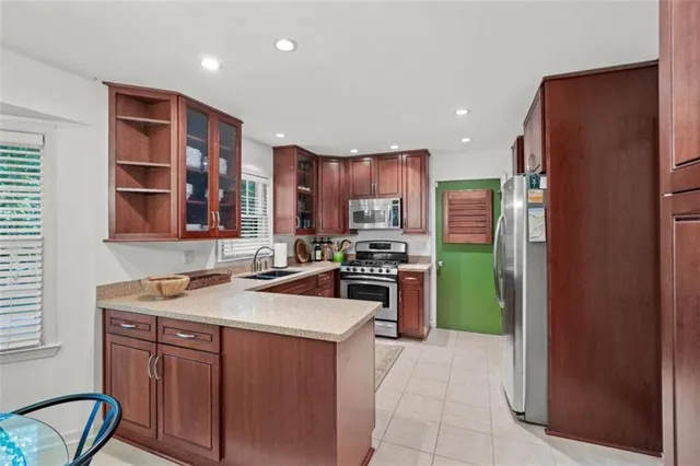 a kitchen with stainless steel appliances granite countertop a refrigerator sink and cabinets