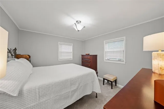 a bedroom with a bed and a lamp with window