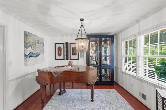 a dining room with furniture a chandelier and window