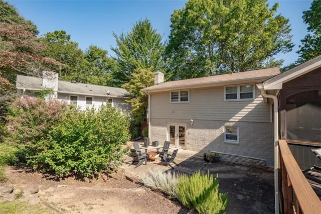 a view of a house with backyard and sitting area