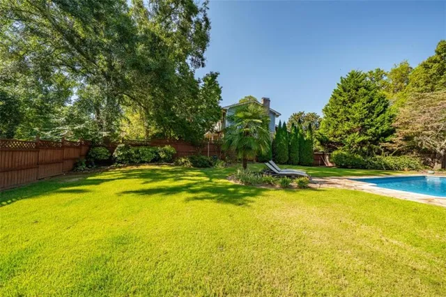 a view of a swimming pool with an outdoor space and seating area
