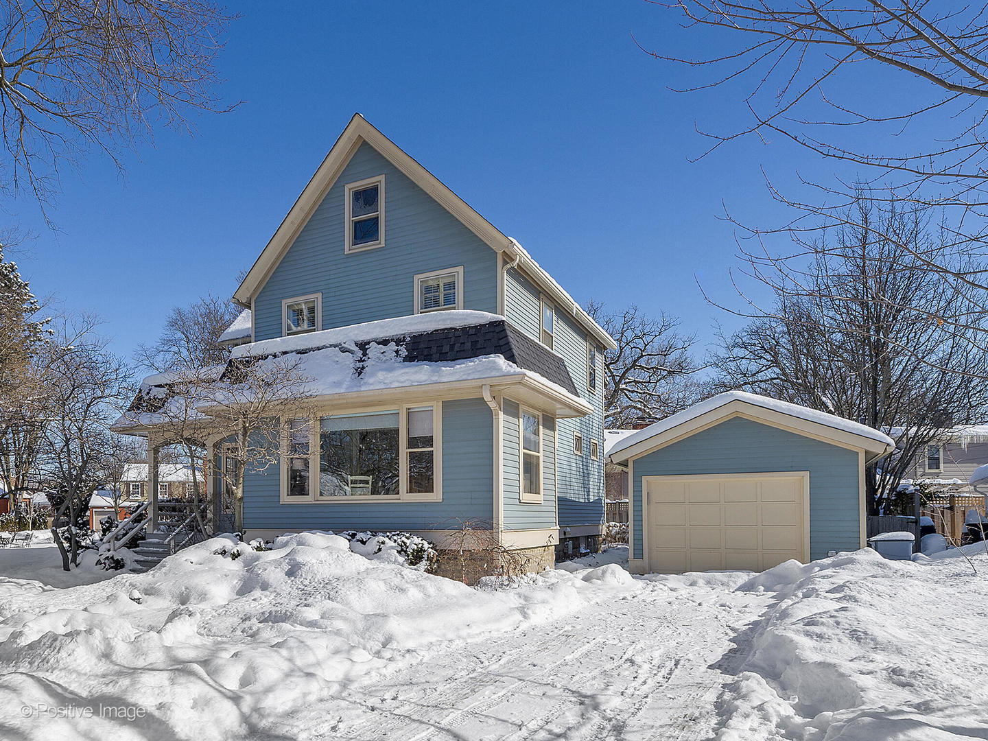 213 Woodside Road Riverside, IL 60546 - Photo 2 of 35 a front view of a house with a yard covered in snow