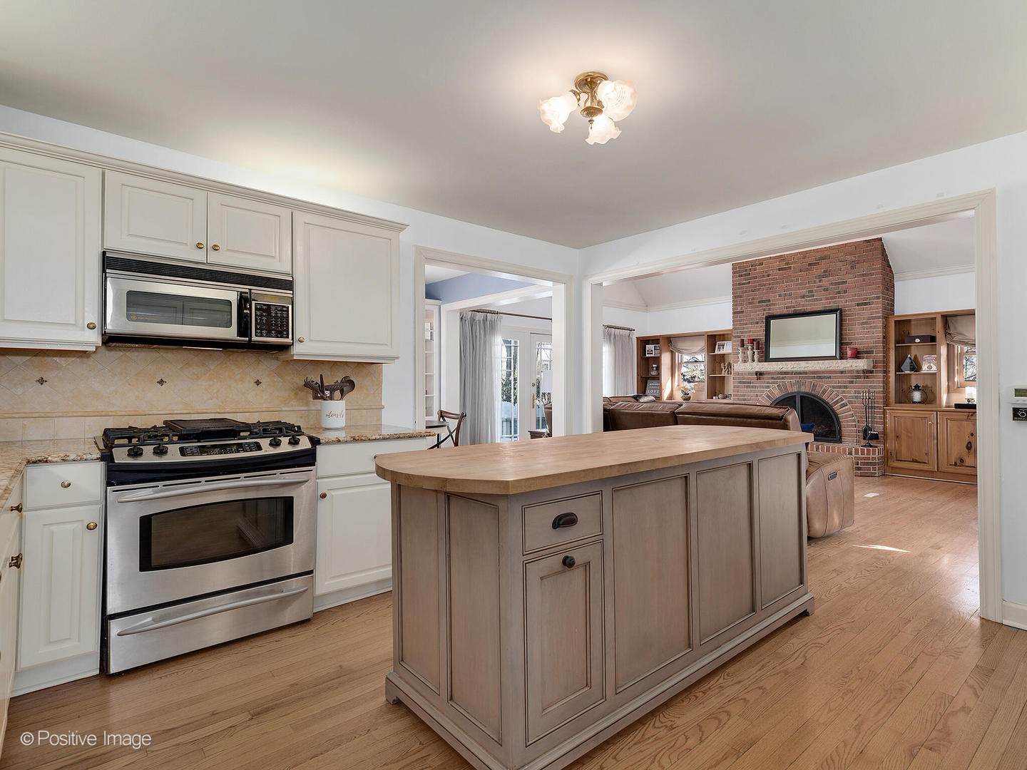 213 Woodside Road Riverside, IL 60546 - Photo 14 of 35 a kitchen with kitchen island granite countertop a sink cabinets and stainless steel appliances