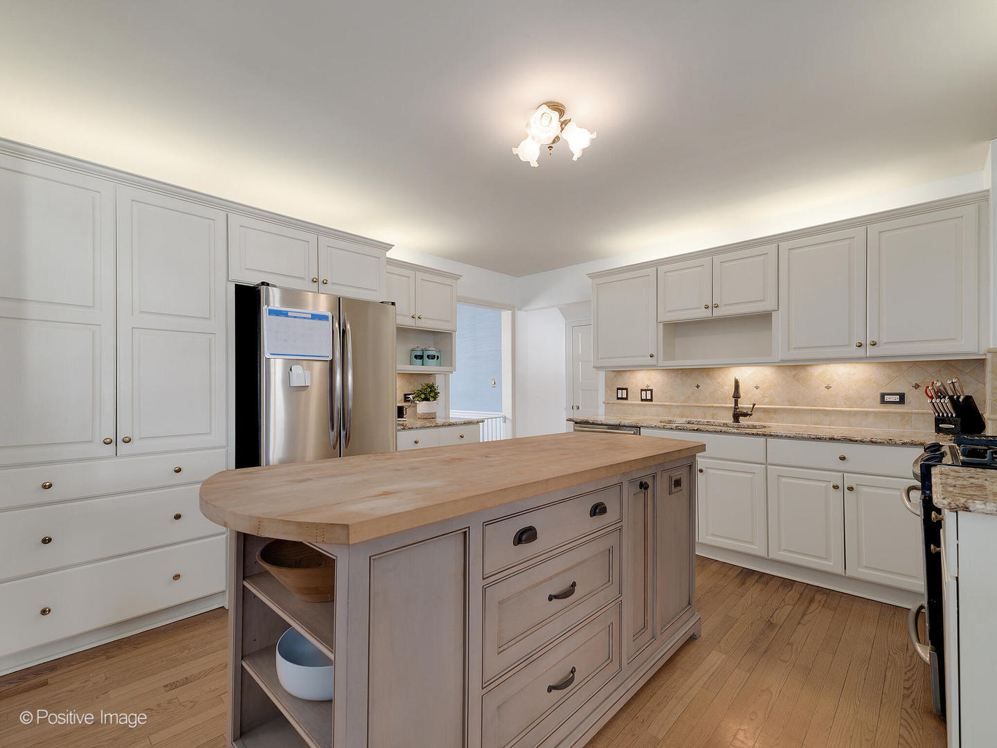 213 Woodside Road Riverside, IL 60546 - Photo 15 of 35 a kitchen with a stove a sink and a refrigerator