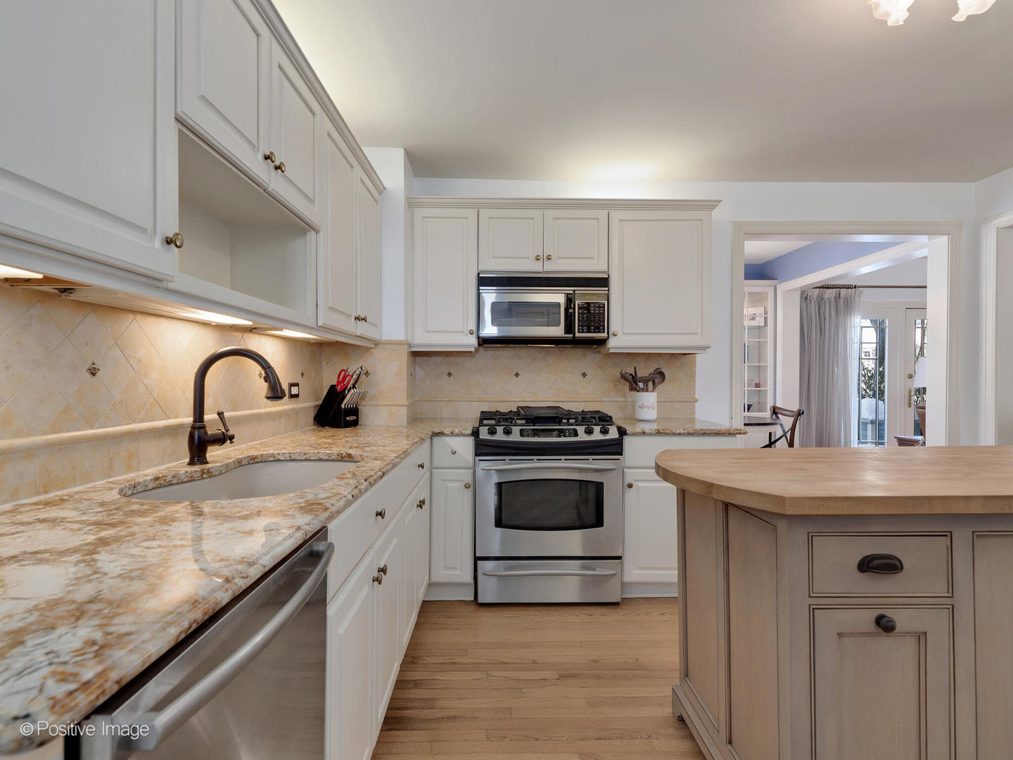 213 Woodside Road Riverside, IL 60546 - Photo 18 of 35 a kitchen with granite countertop a sink stove and cabinets