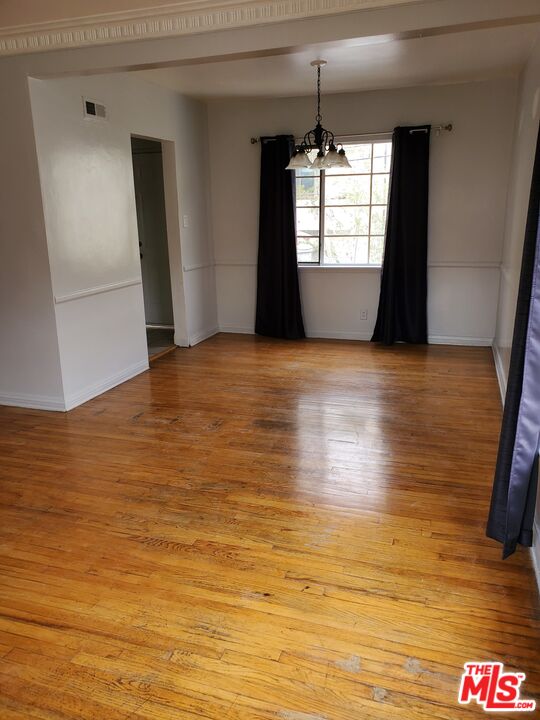 127 North Clark Drive Beverly Hills, CA 90211 - Photo 3 of 9 a view of empty room with wooden floor and fan